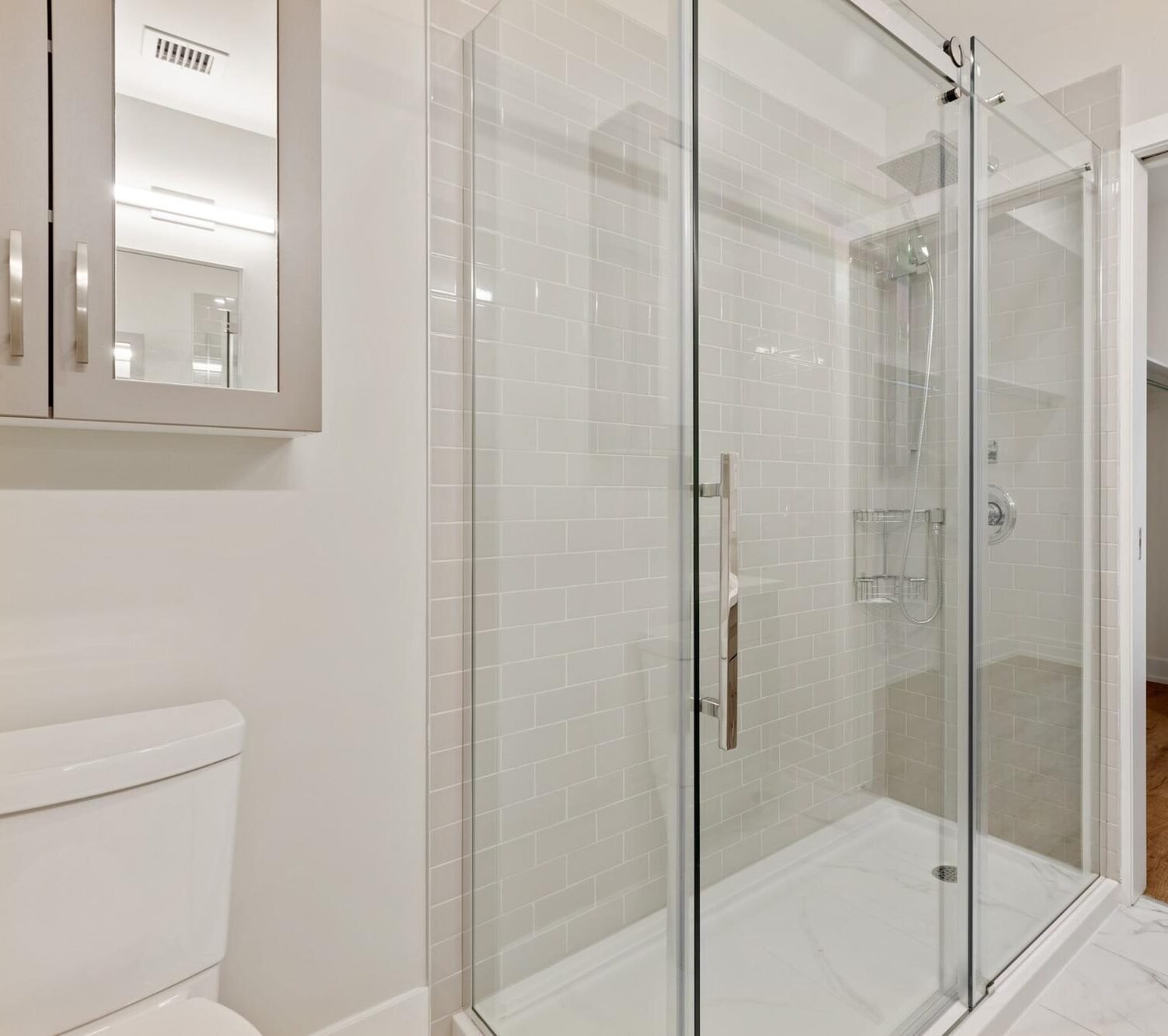 Move-out deep clean example showing streak-free shower glass and empty master bedroom in East County San Diego