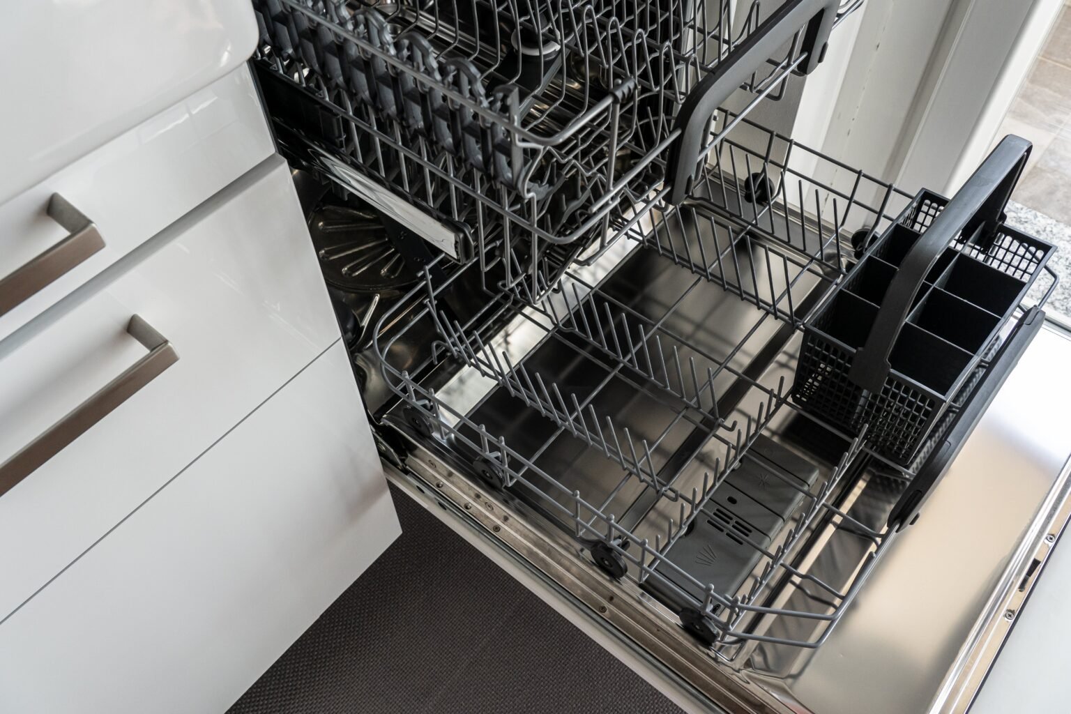 Open dishwasher with empty racks