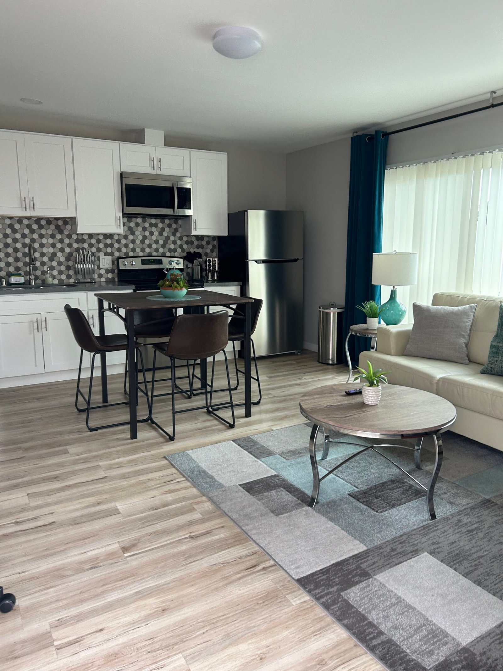Open-concept kitchen and living area with floors, counters, and surfaces freshly cleaned during a Suddenly Clean recurring visit