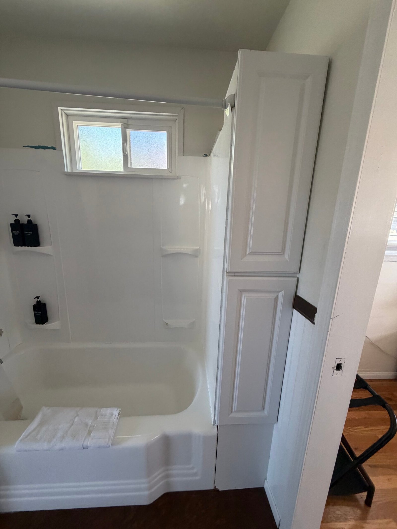 Clean bathroom tub and cabinet