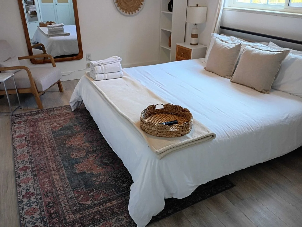 Neatly made bed with a tidy basket, ready for a fresh move-in