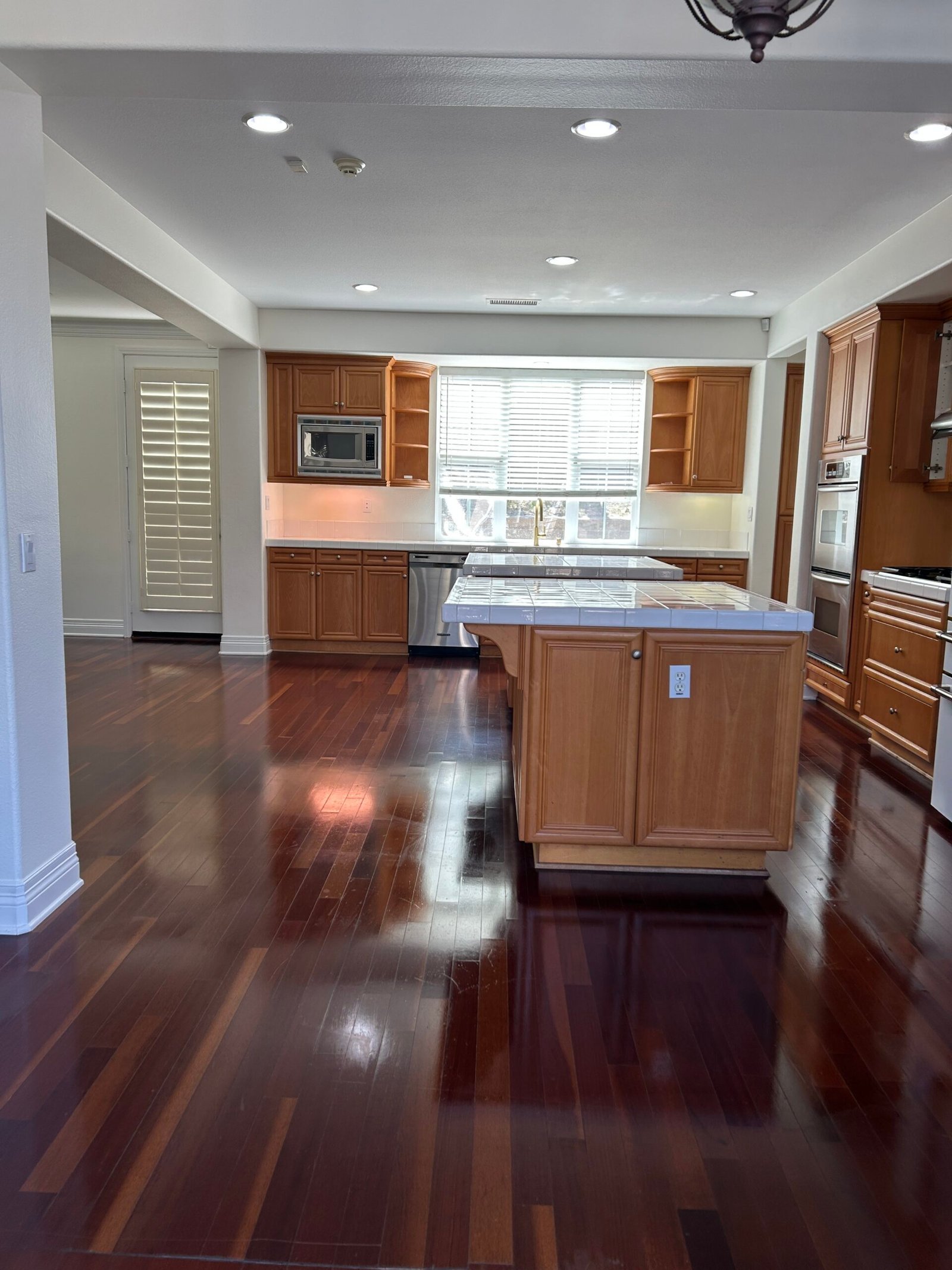 Clean kitchen with cabinets and wood flooring