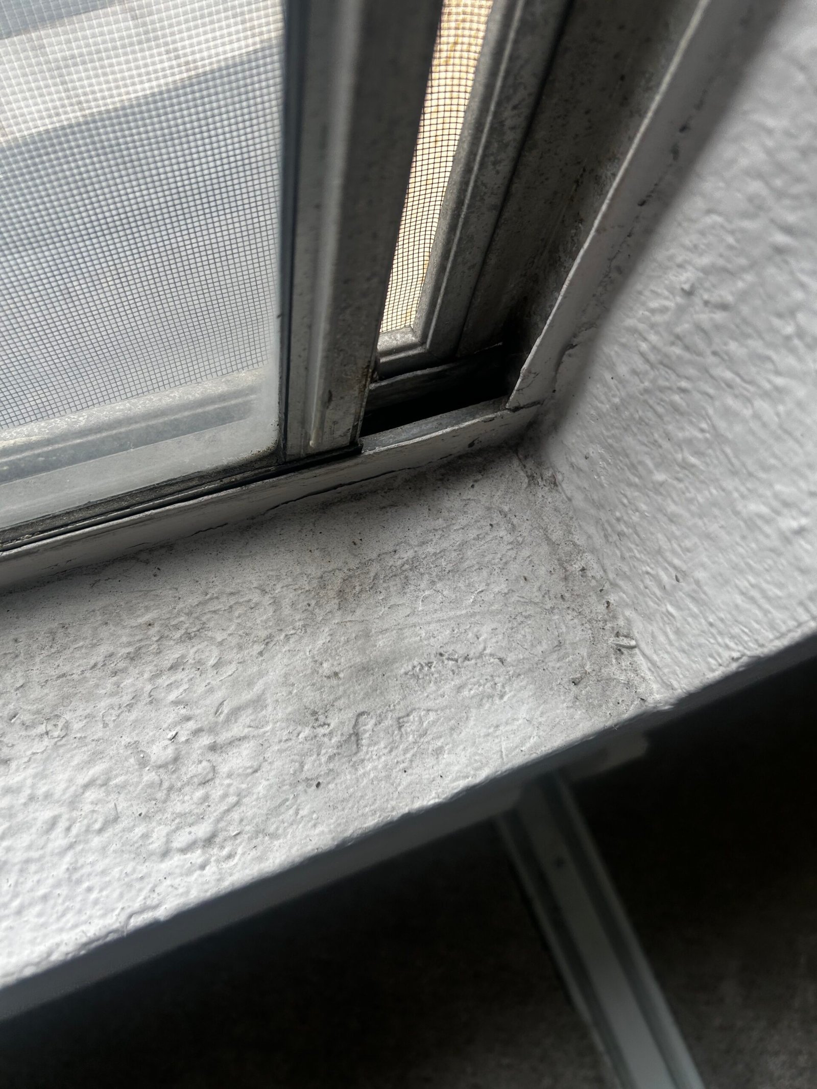 Detail cleaning of a dusty window screen track and corner