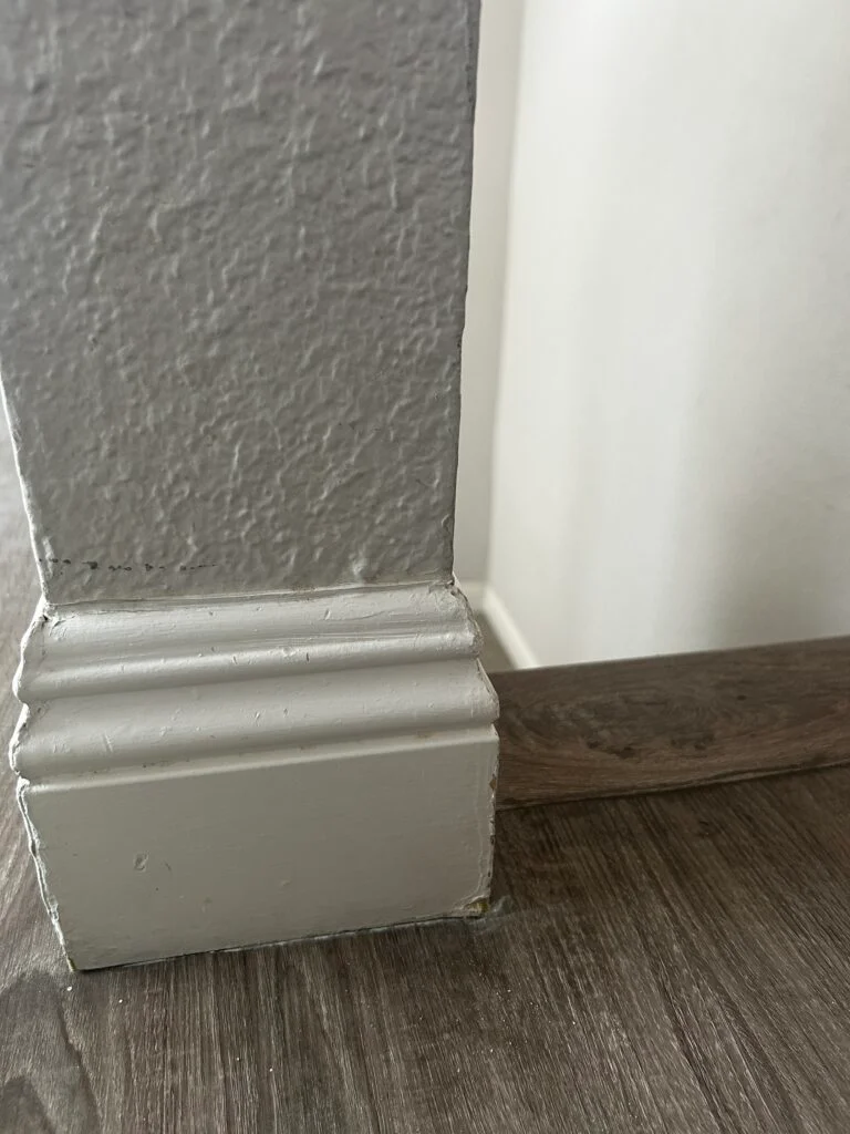 Clean baseboard and crown molding detail in a corner