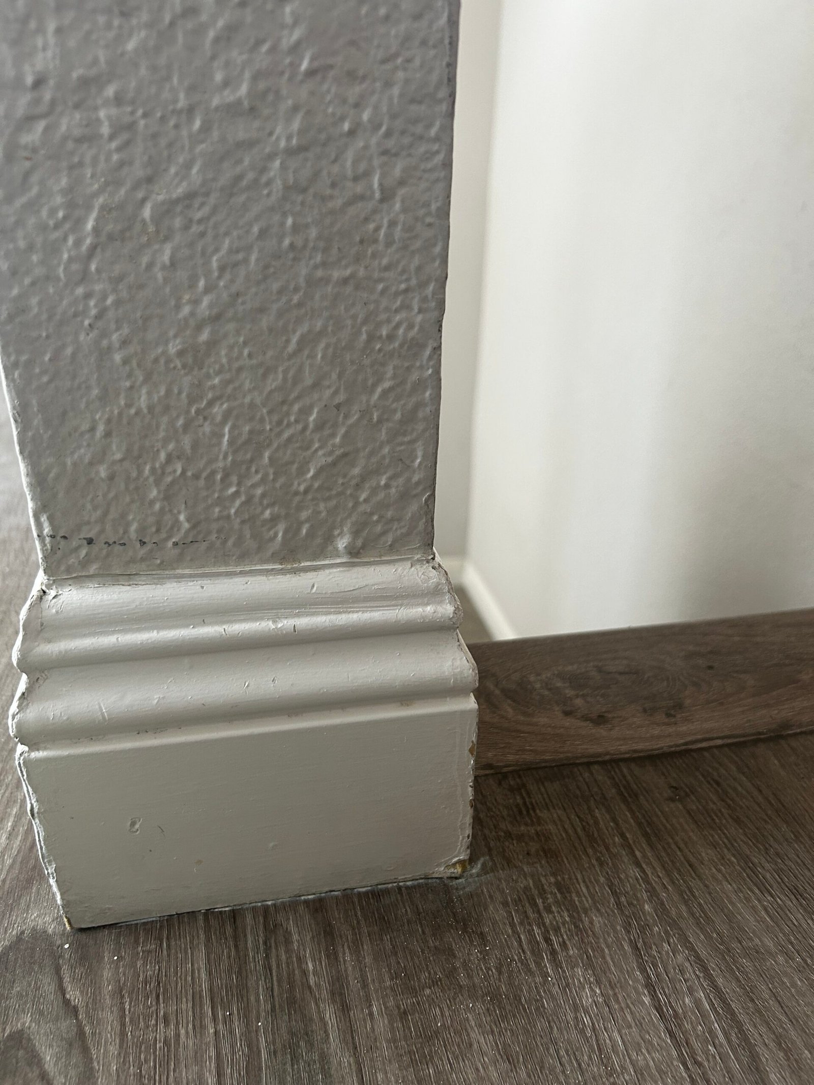 Clean crown molding and baseboard detail in a corner