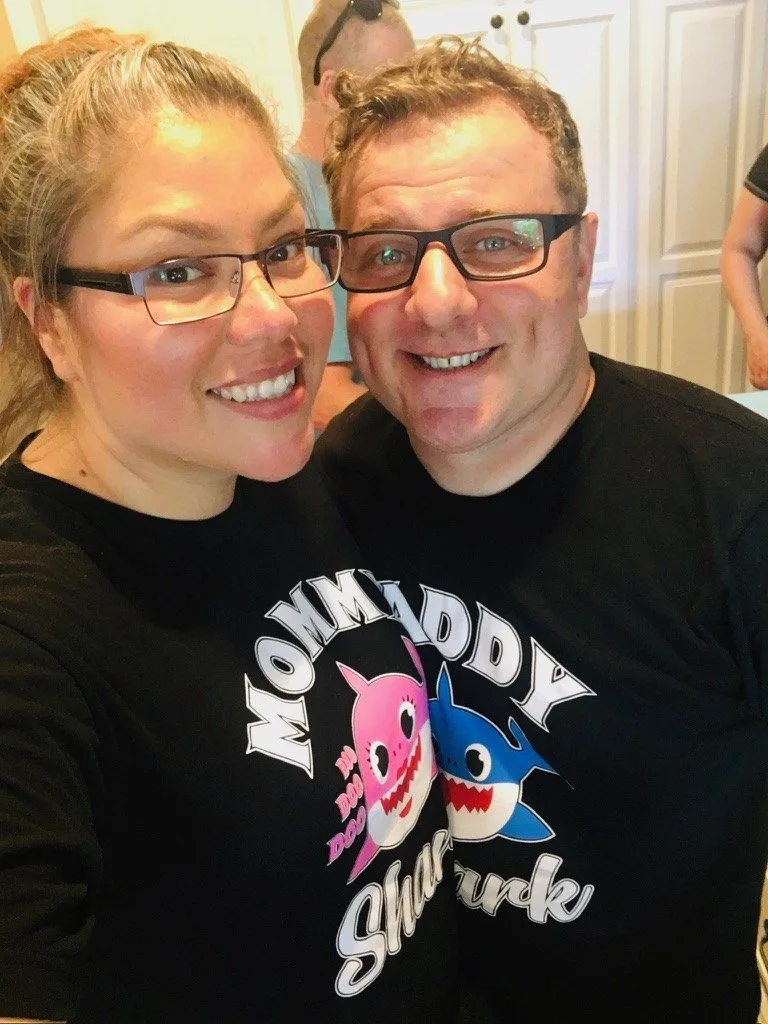 Paul and Lina smiling together in matching Mommy and Daddy shark shirts, before Suddenly Clean started