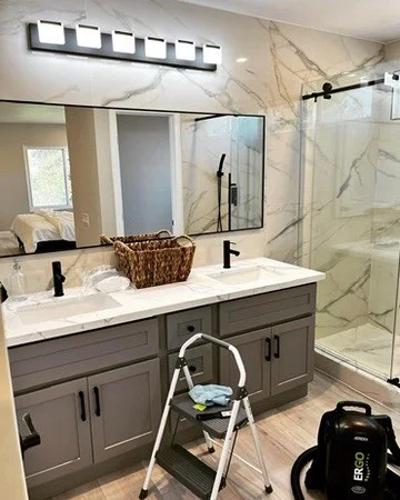 A step ladder, vacuum, and cleaning equipment set up during an active Suddenly Clean cleaning job