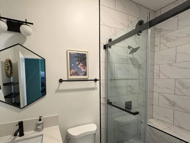 Clean bathroom shower glass, tile, and vanity after a Suddenly Clean visit