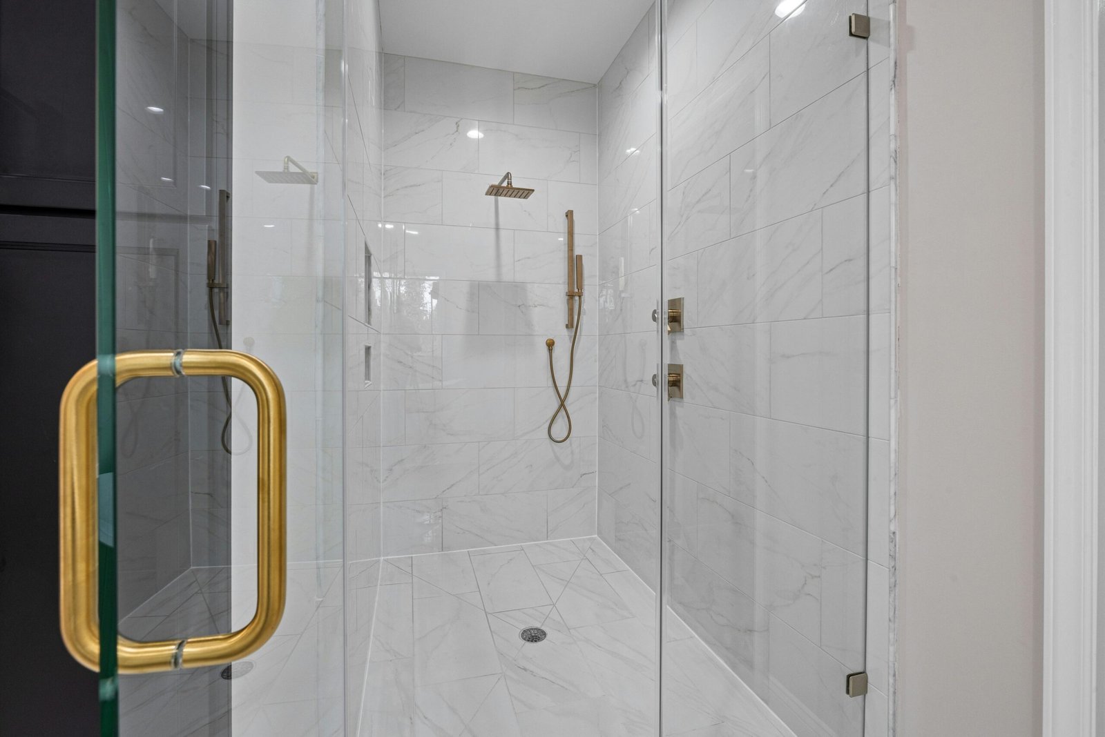 Glass shower with marble tile in a Bonita home