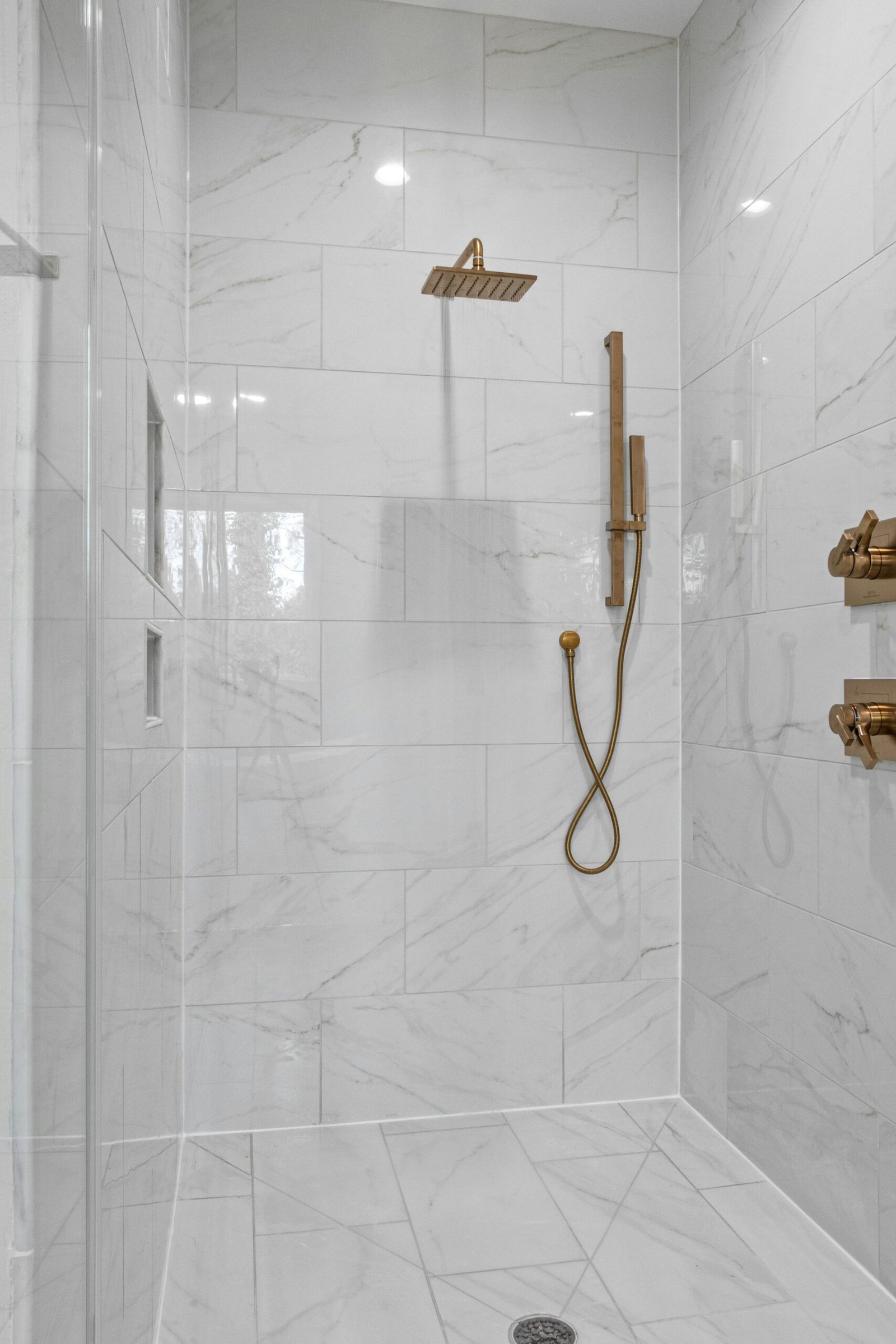 Bathroom shower with marble tile in a Bonita home
