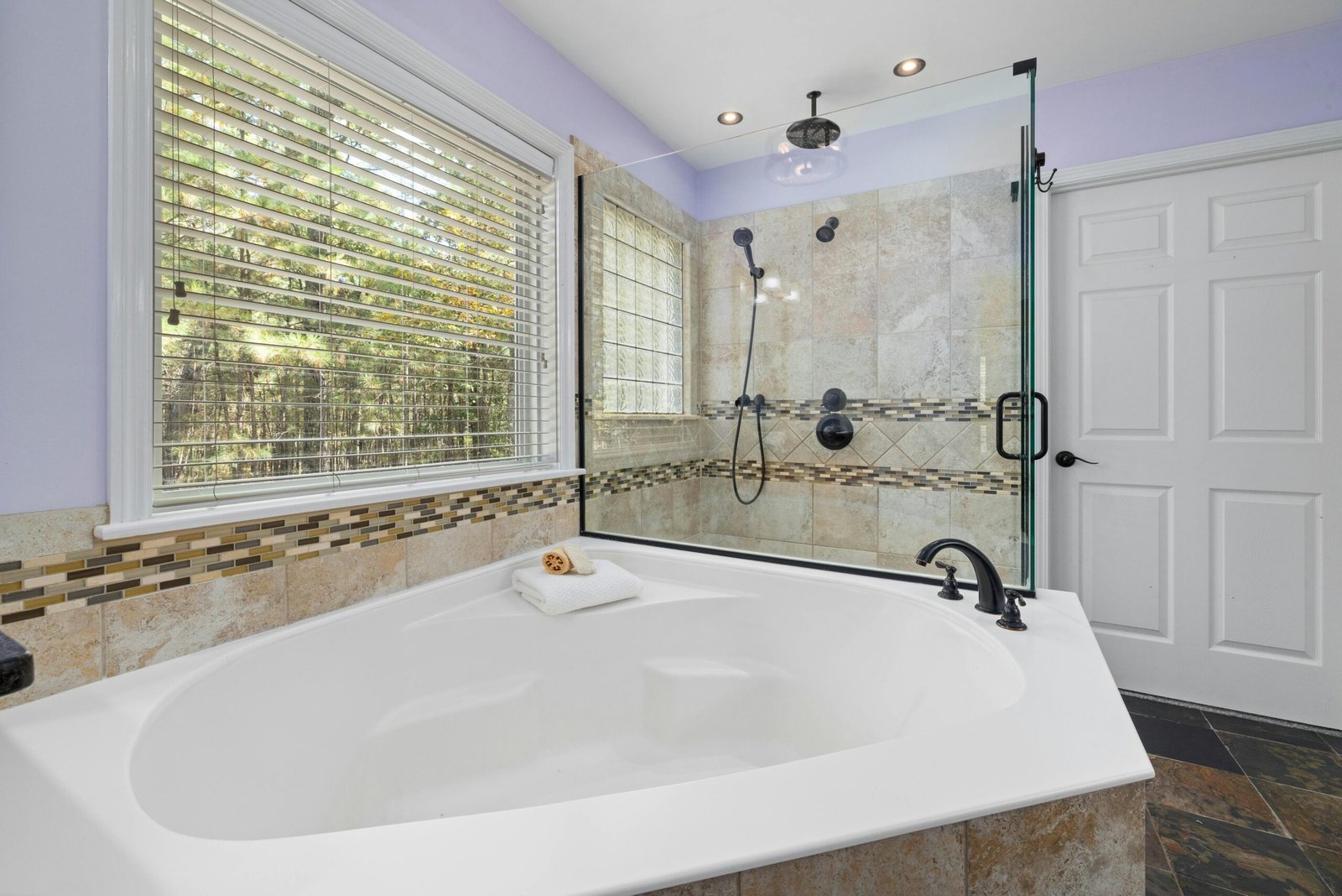Bathroom with soaking tub and glass shower in a Bonita home