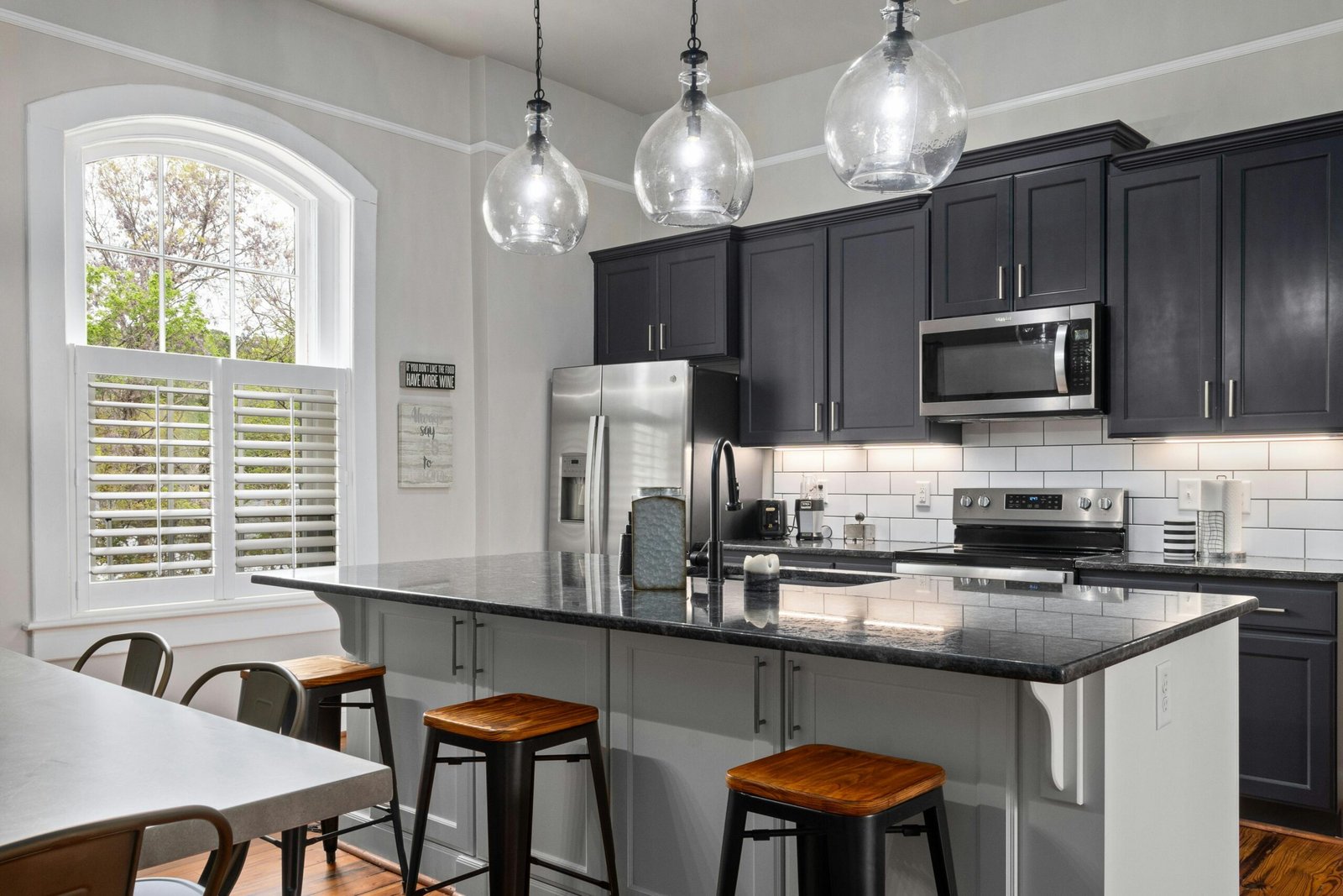 Kitchen with dark cabinetry and pendant lighting in a Bonita home