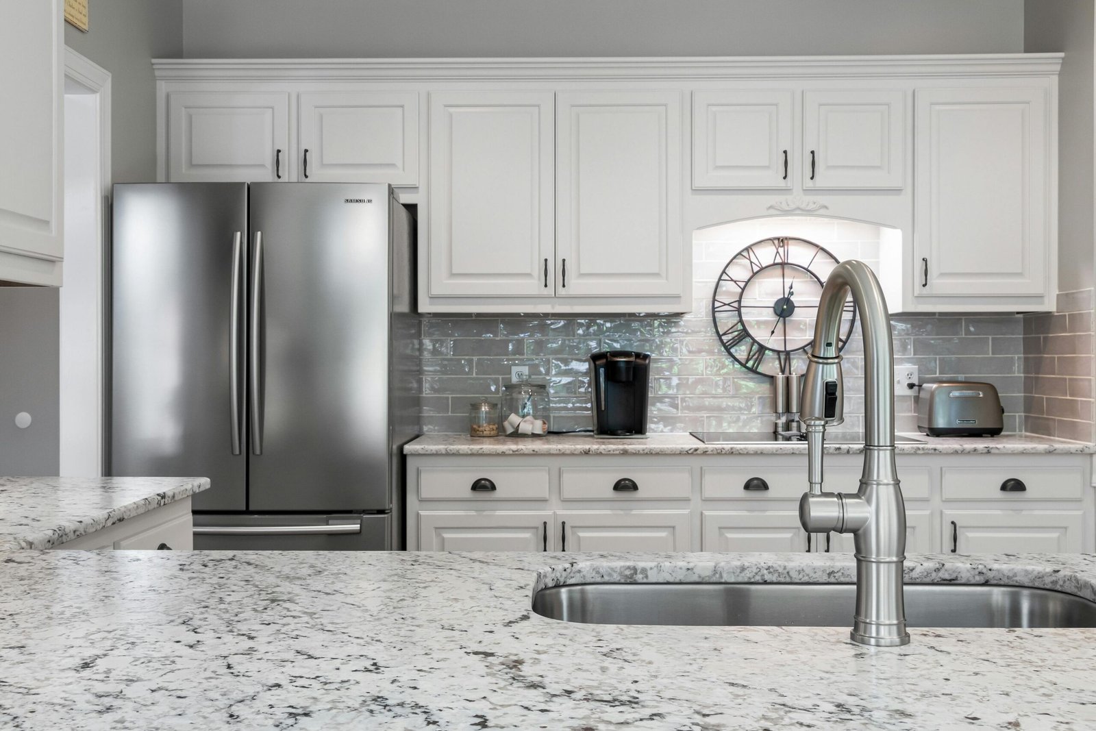 White kitchen with stainless steel refrigerator in a Bonita home