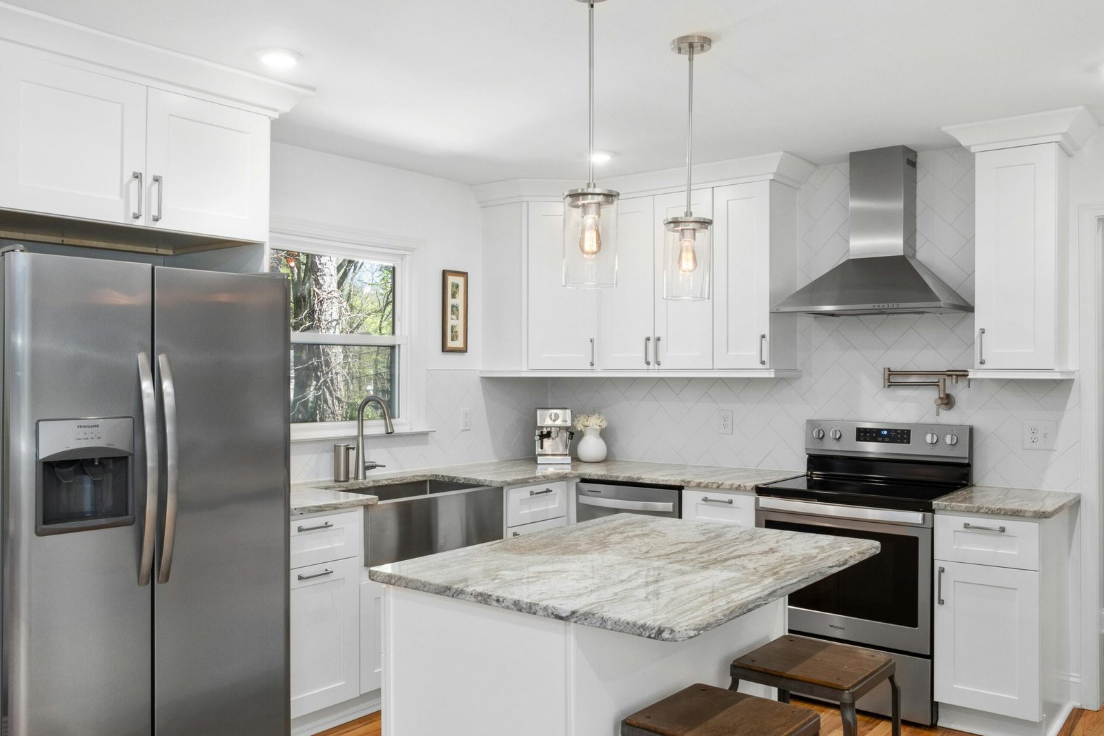 White kitchen with farmhouse sink and island in a Bonita home