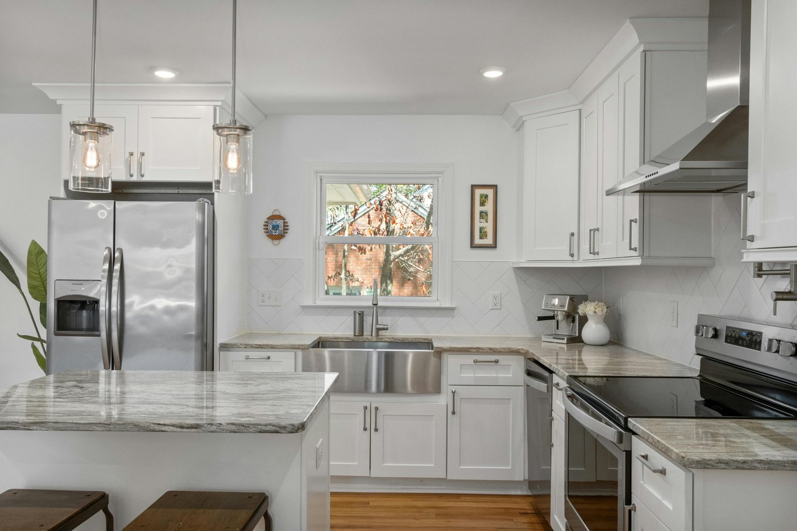 White kitchen with stainless steel appliances in a Bonita home