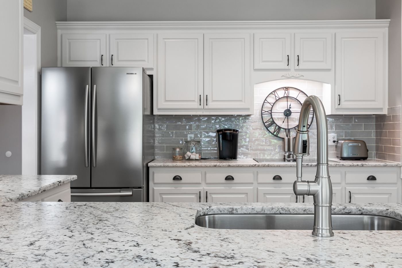 Granite counter and sink with stainless refrigerator