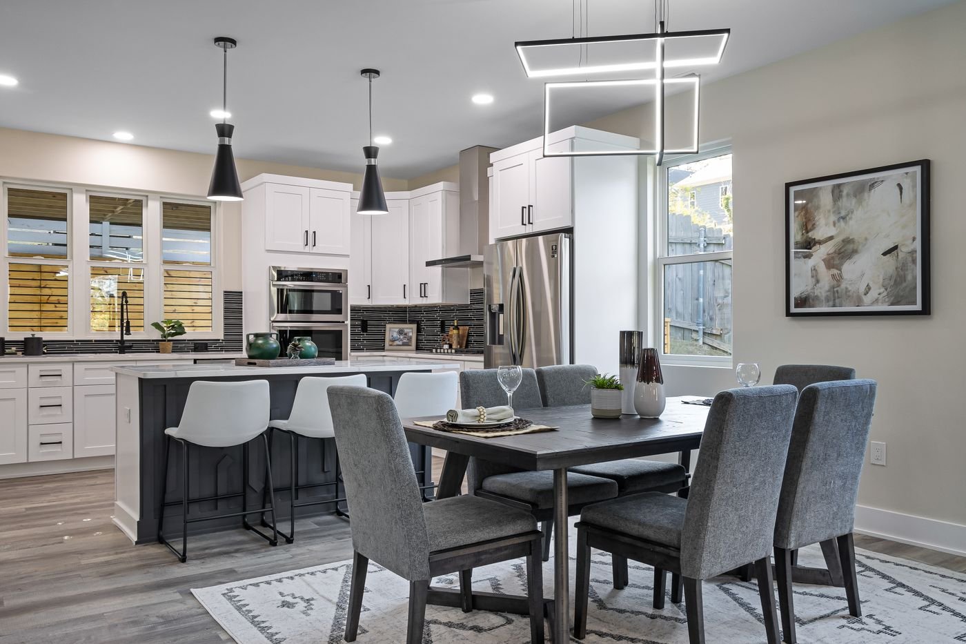 Kitchen and dining area with island seating and pendant lights
